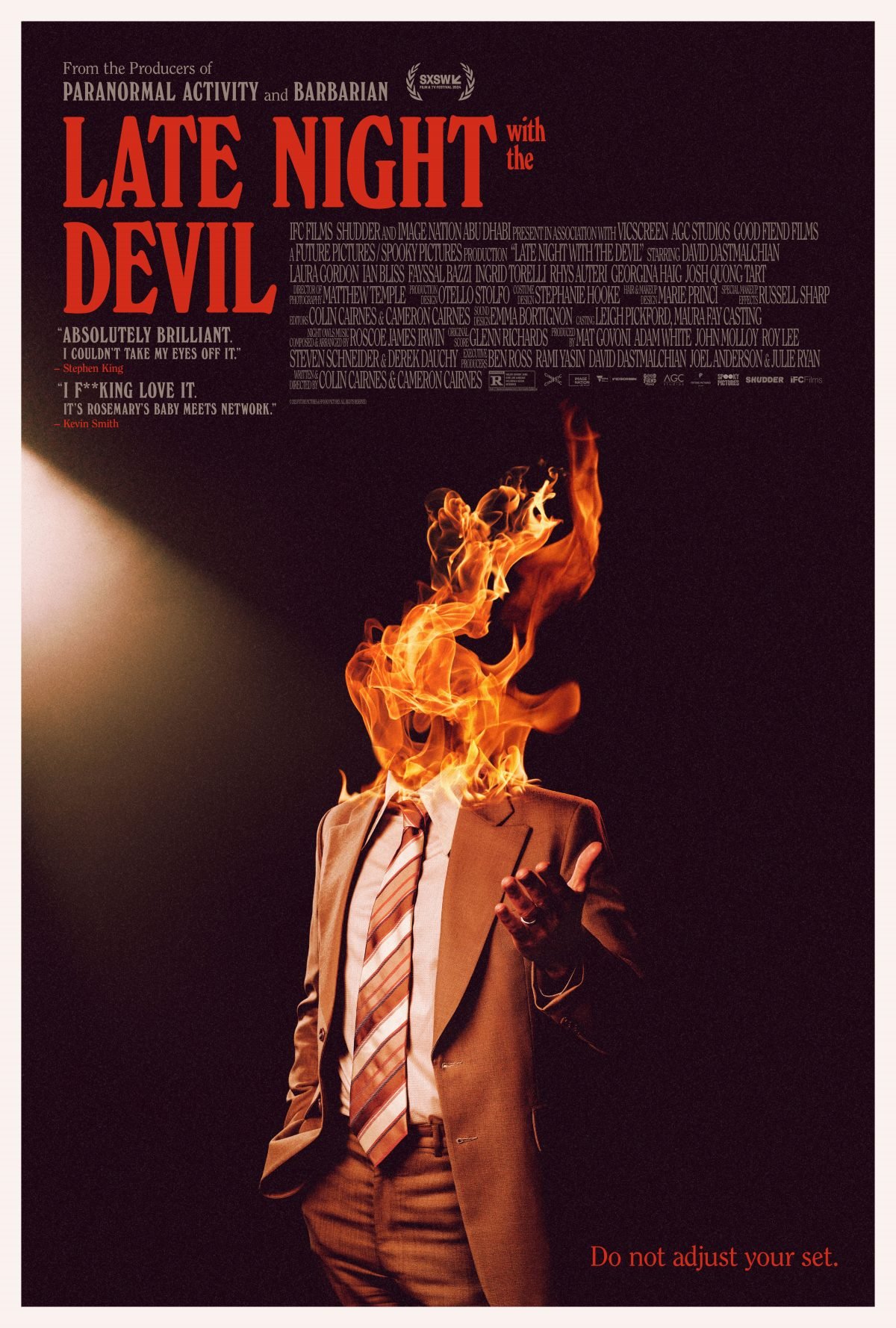 Late Night with the Devil poster showing a man in a suit with fire instead of a head