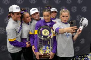 March 23, 2024: LSU gymnast Haleigh Bryant, Olivia Dunne, KJ Johnson, Chase Brock, Alexis Jeffrey and Annie Beard pose with the SEC Championship Trophy after NCAA Gymnastics action in the SEC Championships at the Smoothie King Center in New Orleans, LA. Jonathan Mailhes/CSM (Credit Image: © Jonathan Mailhes/Cal Sport Media) Newscom/(Mega Agency TagID: csmphotothree244973.jpg) [Photo via Mega Agency]