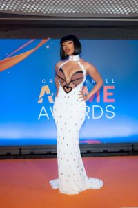Megan Thee Stallion on the orange carpet for the 2024 Crunchyroll Anime Awards sporting a bob haircut and white dress