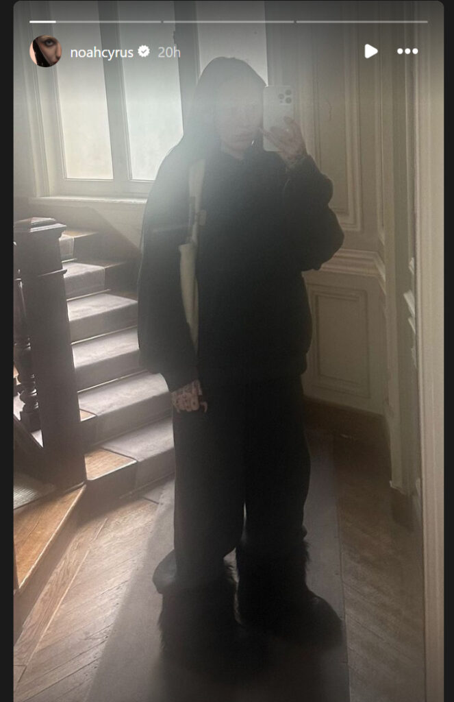 Noah Cyrus looked solemn while wearing dark, baggy clothing in a new photo during a solo outing in Paris, France