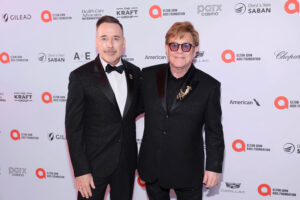 Sir Elton John is in talks to launch a musical, pictured with husband David Furnish