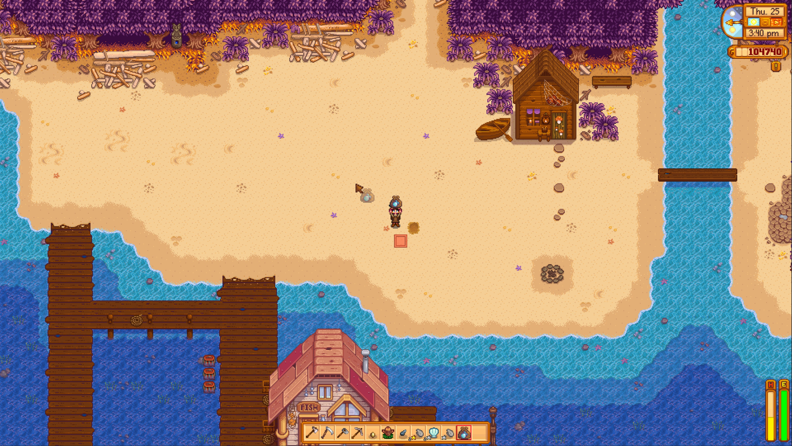 Video game screenshot displaying a character standing on a beach with wood scattered about a pierside house on the edge...