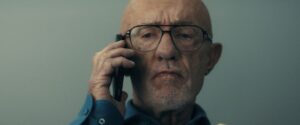 Jonathan Banks in a still from Constellation, looking tense on the phone