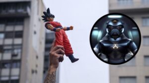 a person holding a goku action figure and toonami tom