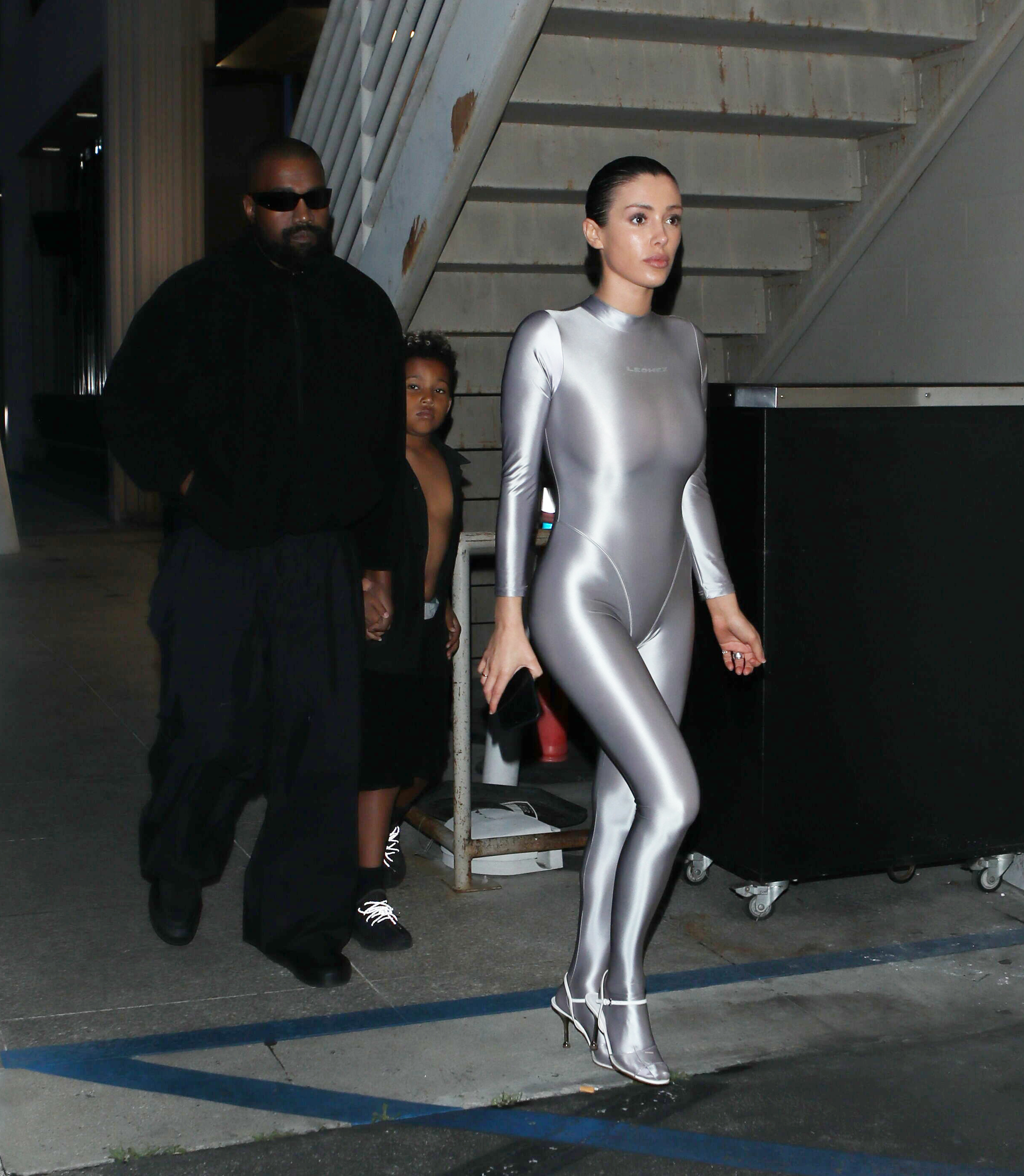 She paired the suit with silver high heels and her hair styled in a sleek bun
