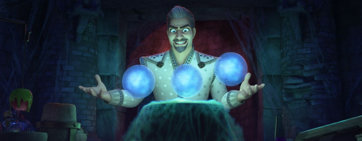 King Magnifico (voiced by Chris Pine) in the animated Disney movie Wish grins evilly as he holds his hands out to three floating, glowing blue balls in a dark room