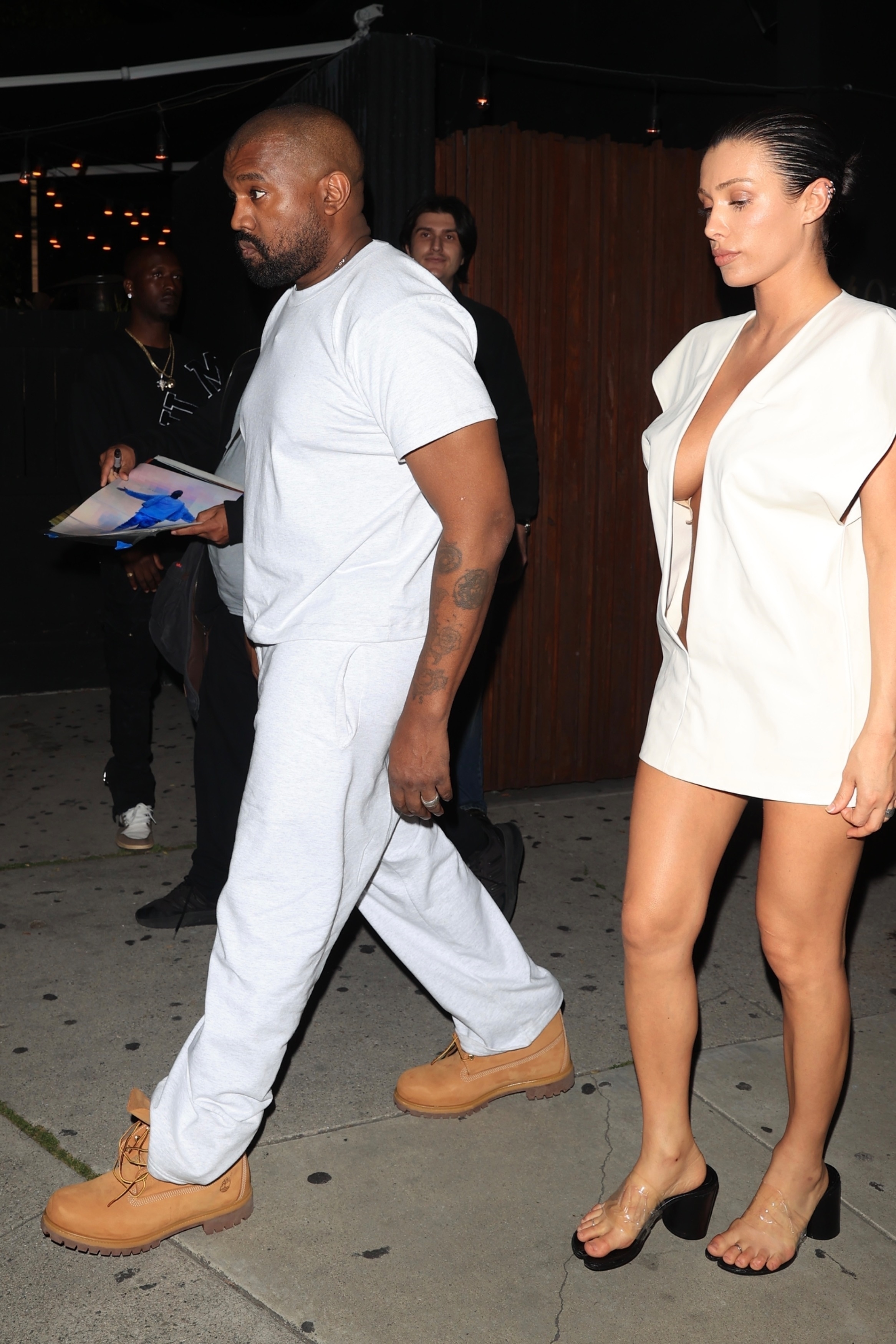 Kanye opted for a casual look, in white sweatpants and Timberland boots