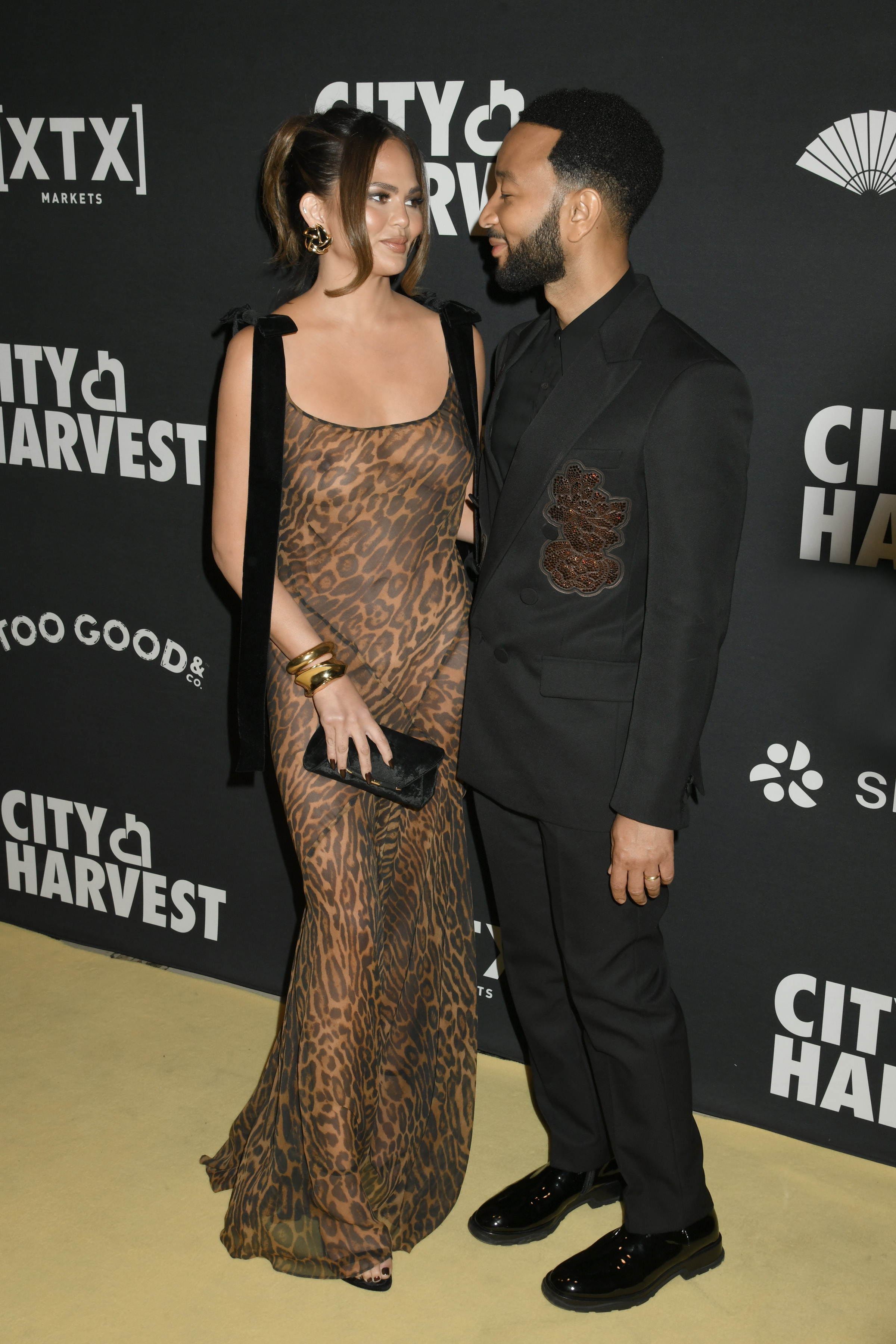 Chrissy pictured with her husband John Legend, who wore an all-black ensemble