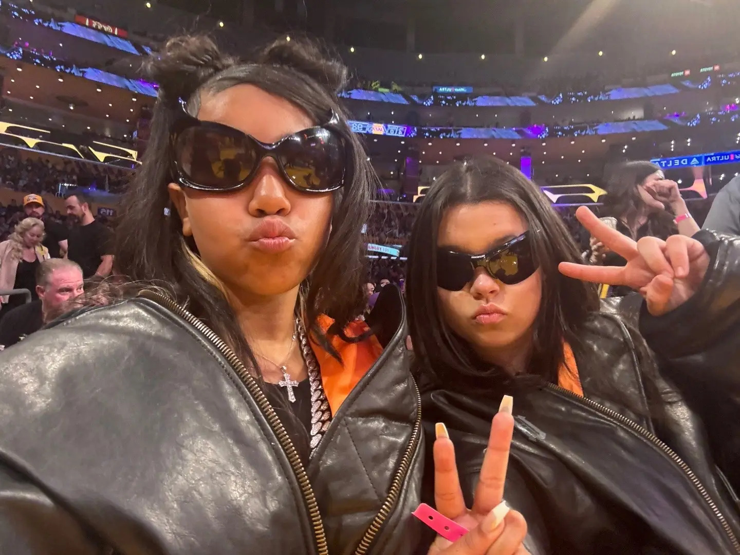 North included several selfies of her and her friend sitting courtside