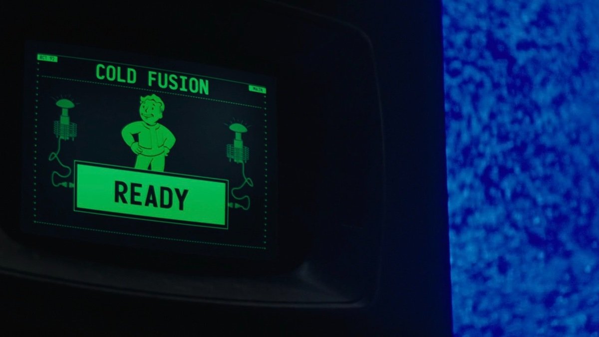 Vault Boy on a green screen next to blue liquid on Fallout