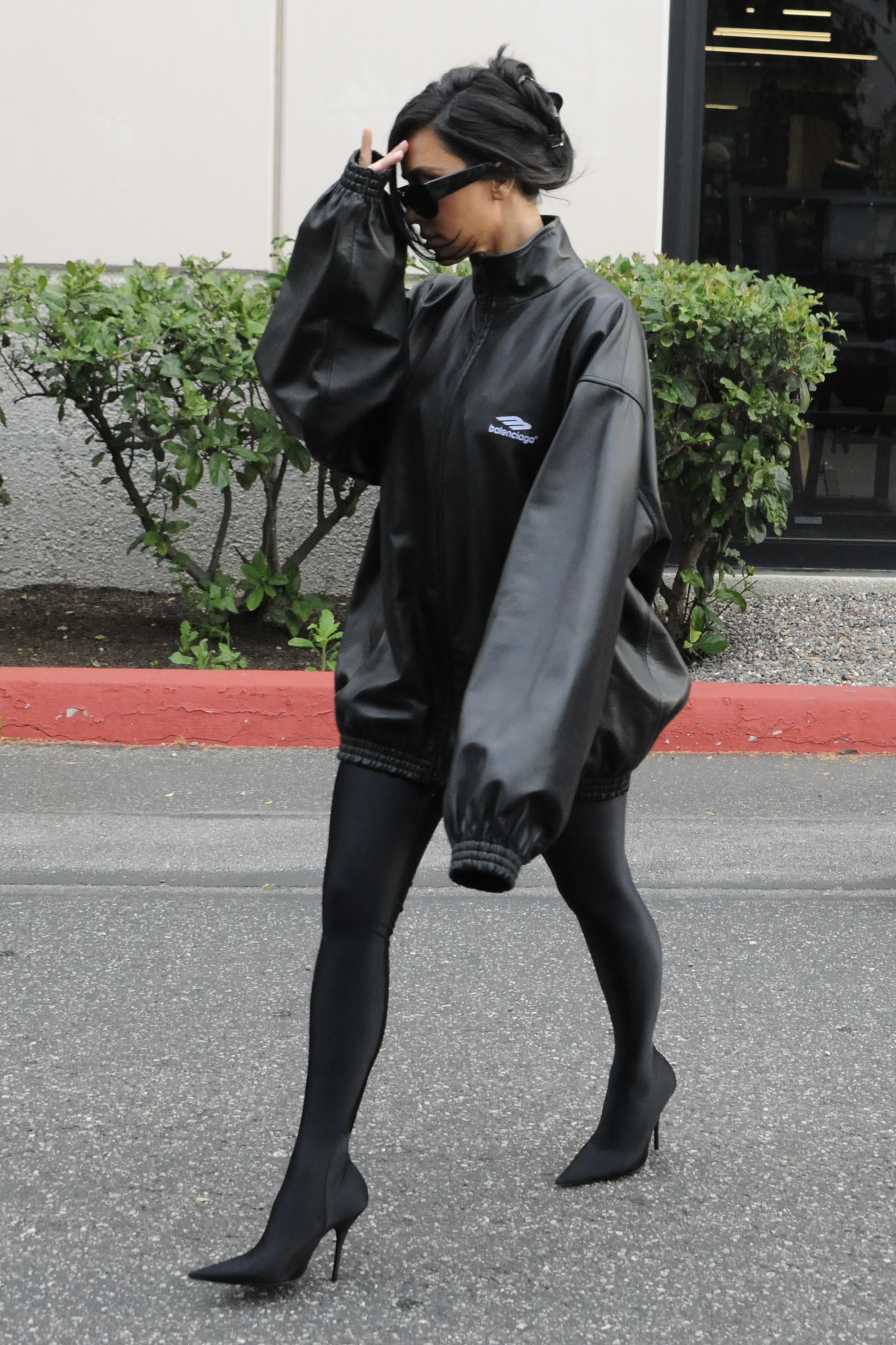 Kim paired her puffy black sleeves with a pair of tight black poots
