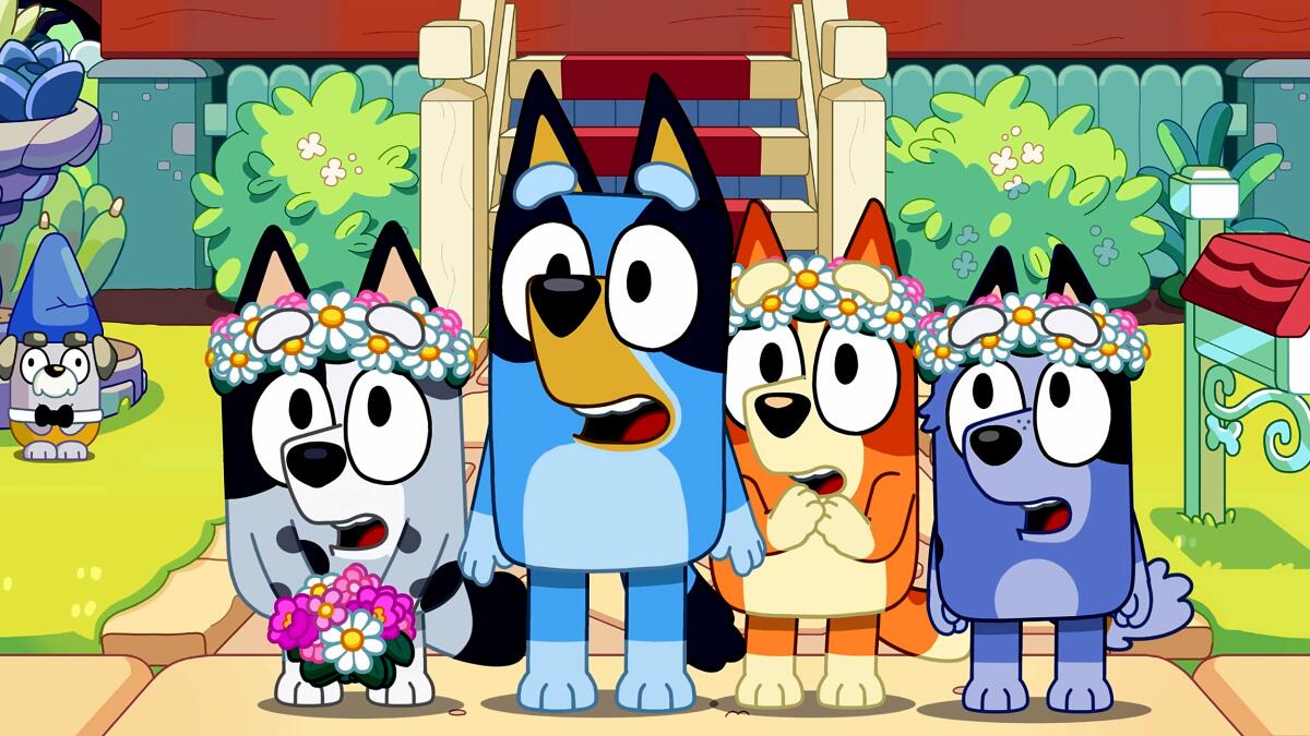 Four animated dogs stand in front of a staircase.