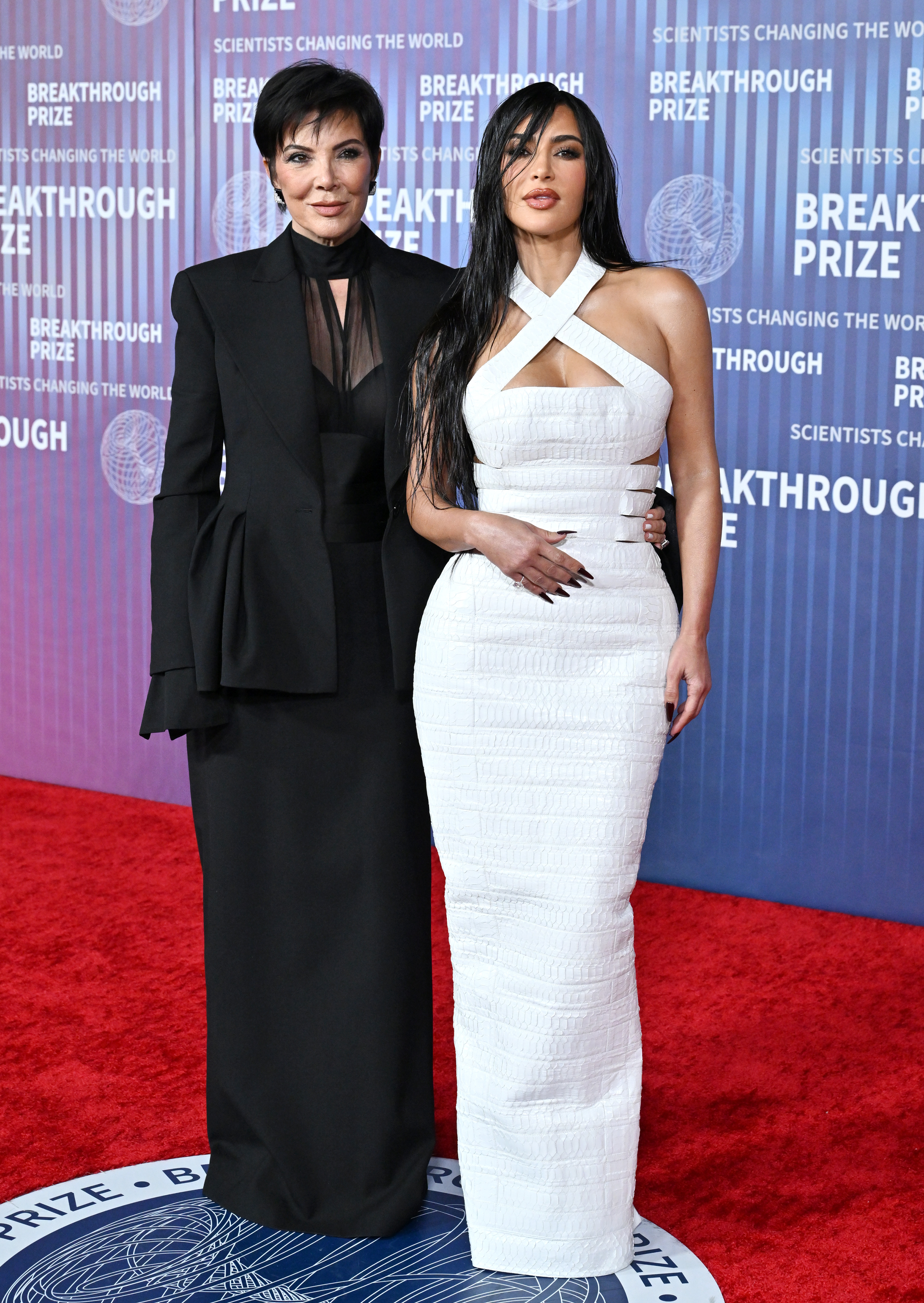 Kim opted for a damp-looking hairstyle with bangs that swept across her forehead as she and her mom posed on the gala's red carpet