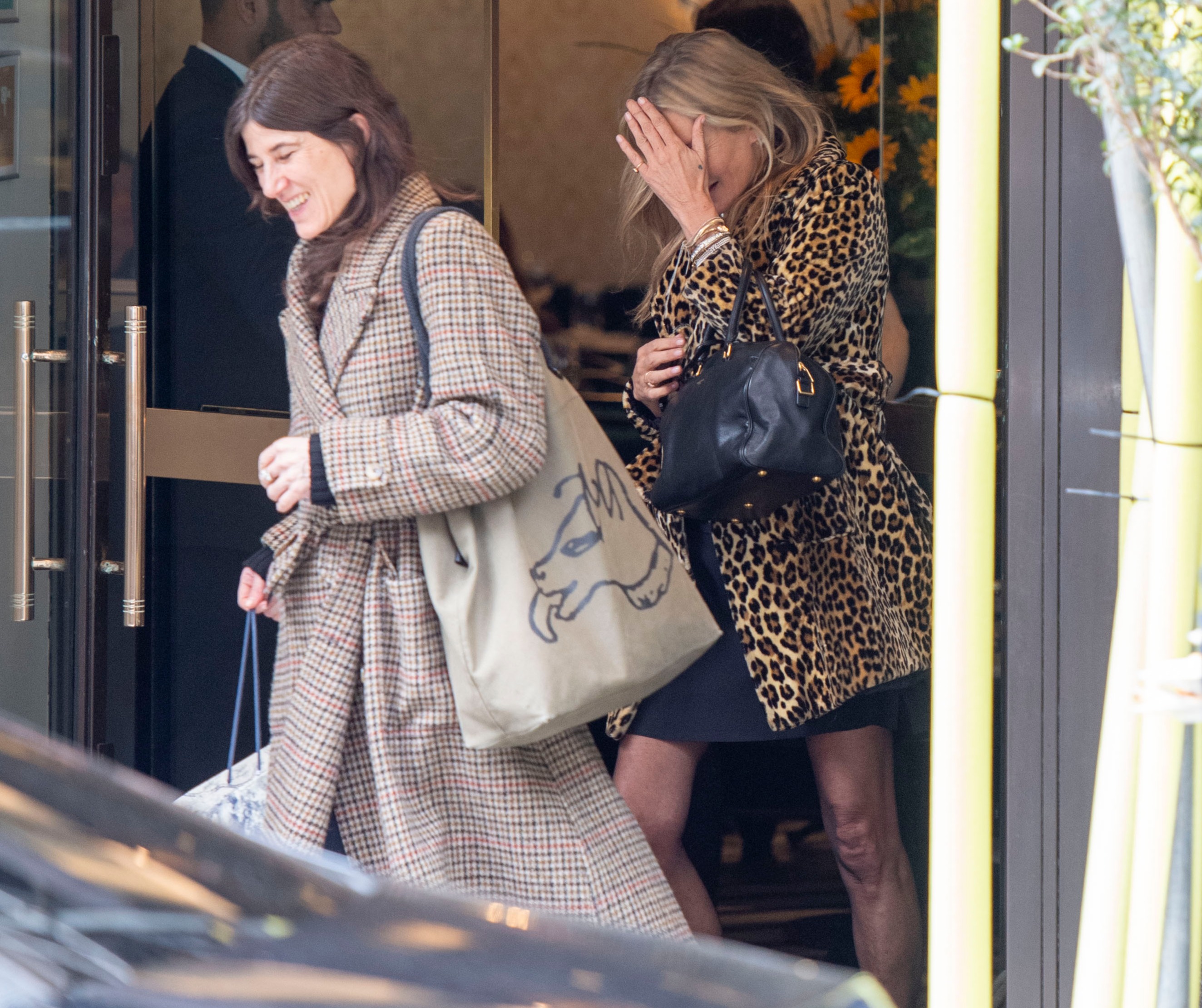Kate tried to hide her face as she left the Mayfair restaurant