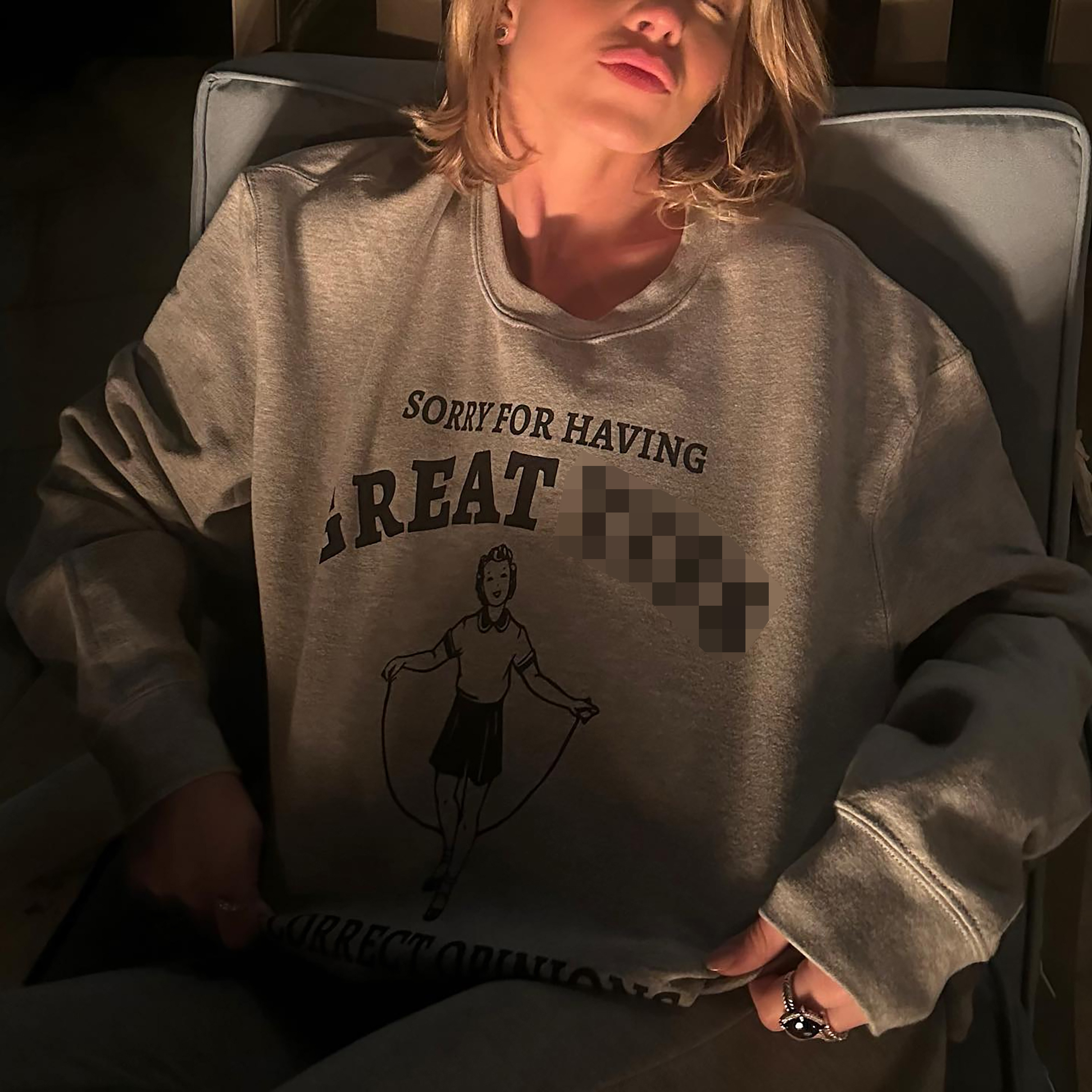 The actress posed in a grey jumper with the slogan: 'Sorry for having great t**s and correct opinions'