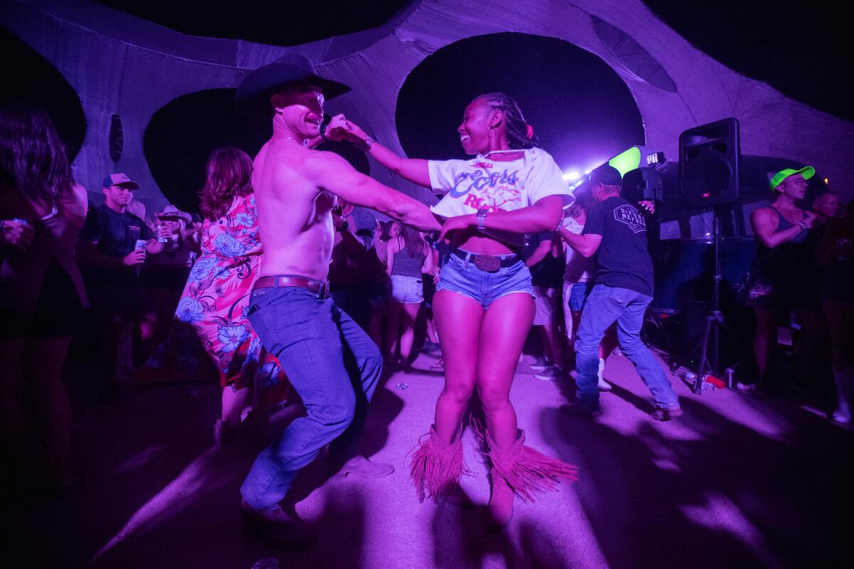 Man and woman line dancing at Stagecoach