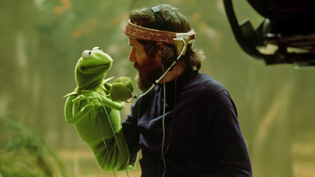 Jim Henson looking at Kermit while he puppeteers the Muppet as part of the Jim Henson documentary trailer