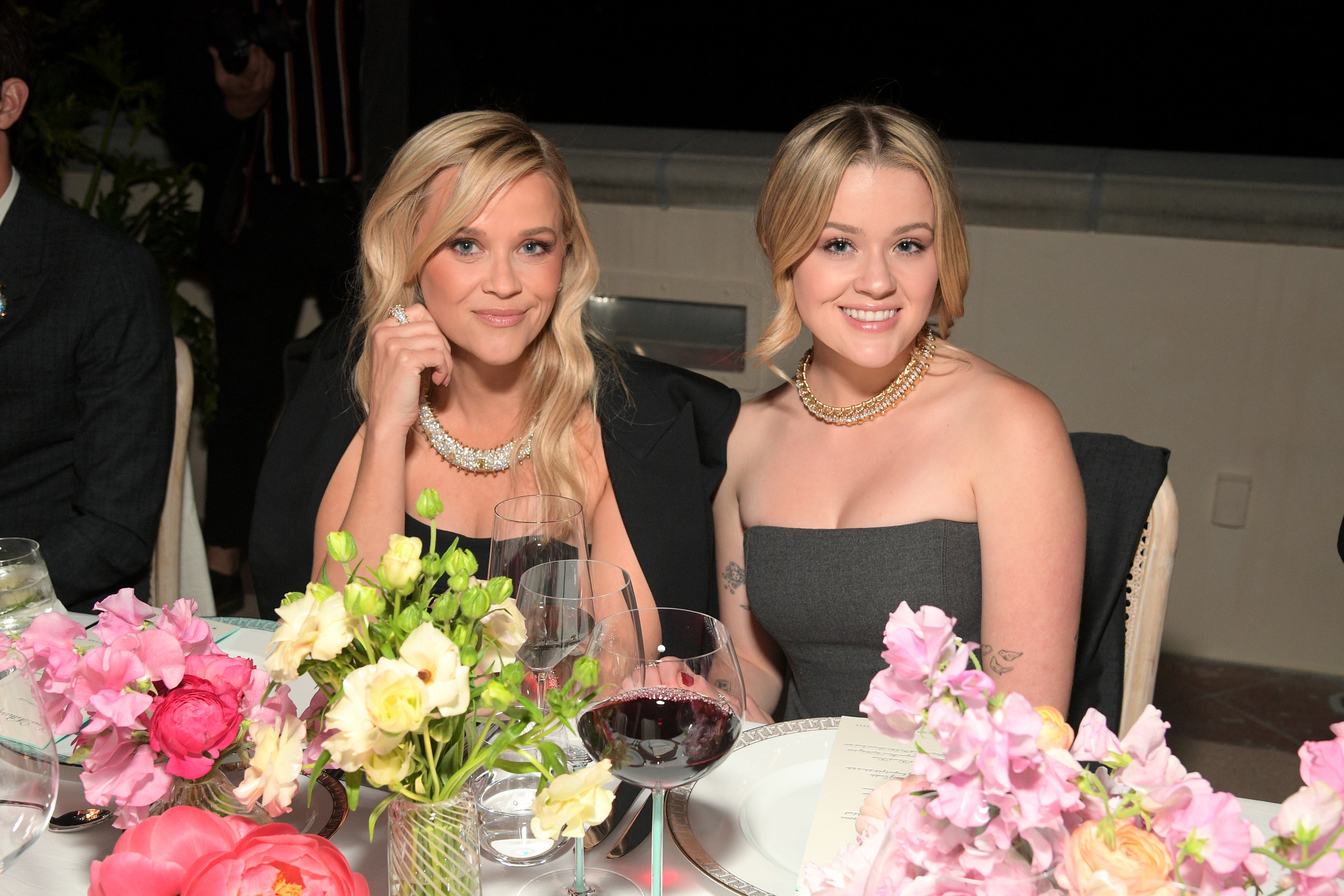 Reese and Ava sat down at a table surrounded by gorgeous flowers during the Tiffany event