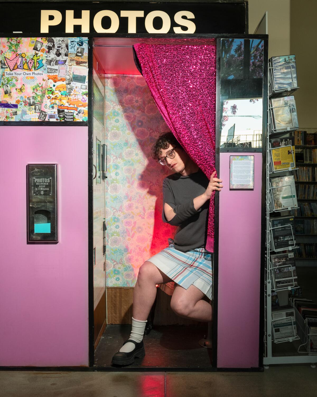 A filmmaker poses in a photobooth.