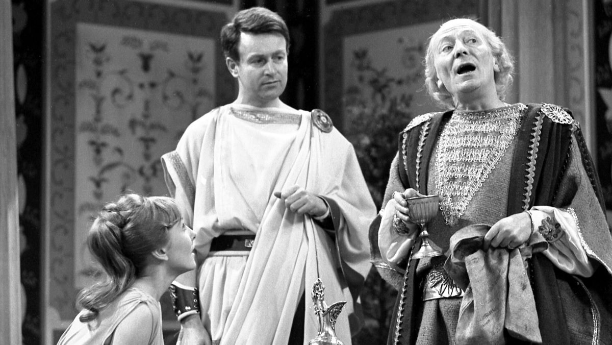 The Doctor, Ian, and Vicki wear togas as the Doctor bloviates on some subject in Doctor Who.