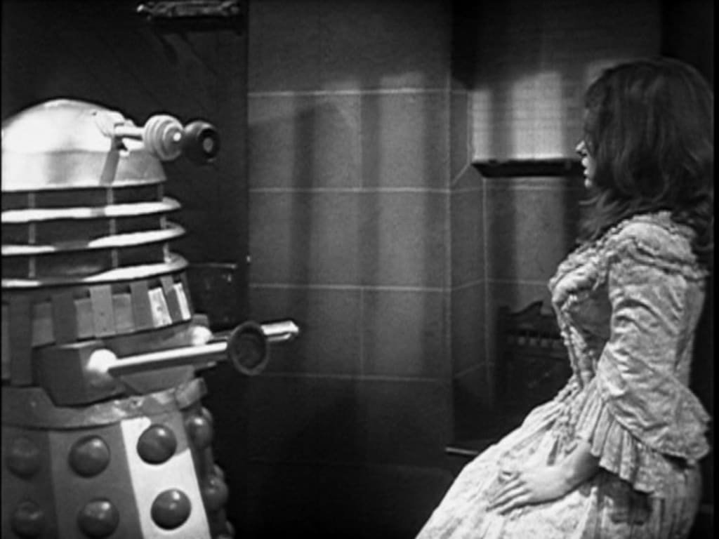 A Dalek confronts Victoria Waterfield in Doctor Who.