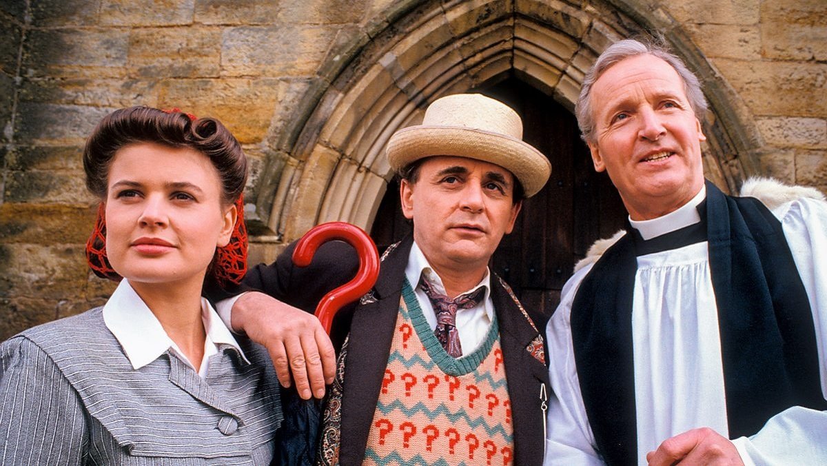 The Doctor, flanked by Ace and a reverend, in the WWII-set Doctor Who story The Curse of Fenric.