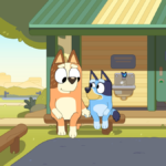 Bluey the cartoon dog and her mom Chilli sit and hold hands outside a cabin next to their parked car