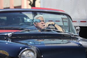 Jay Leno was seen driving a vintage car while looking strained