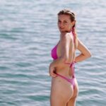Kelsea Ballerini sported a hot pink thong bikini during a vacation with friends