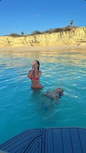 Kylie Jenner and Stassie Karanikolaou swim in the sea.
