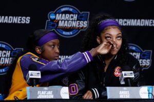 LSU's Flau'jae Johnson, left, is seen wiping Angel Reese's tears during a press conference after the Lady Tigers lost to the Iowa Hawkeyes in the NCAA women's basketball tournament on April 1, 2024, in Albany, New York.