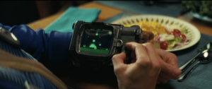 A close-up of someone playing Atomic Command on his Pip-Boy from Fallout episode 1