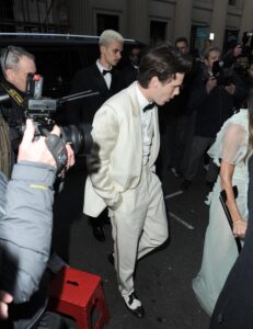 Victoria Beckham arrives at her 50th birthday party at a swanky private members club in crutches