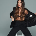 Victoria Beckham showing off her bra in one of her own label’s black suits