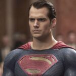 Henry Cavill as Superman looks serious in front of a crowd