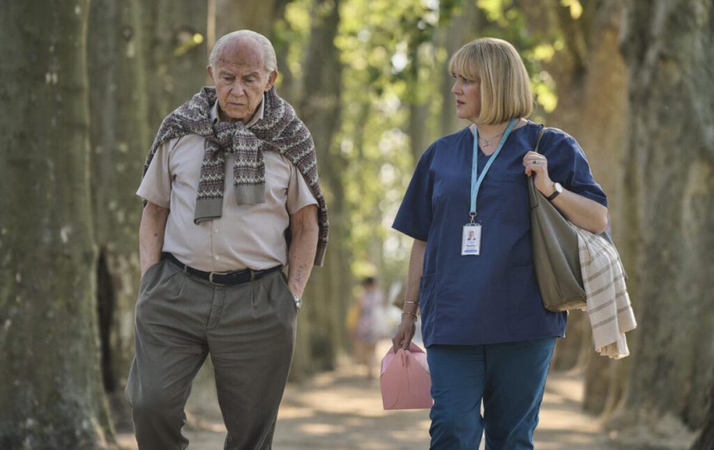 A man and woman walking outside.