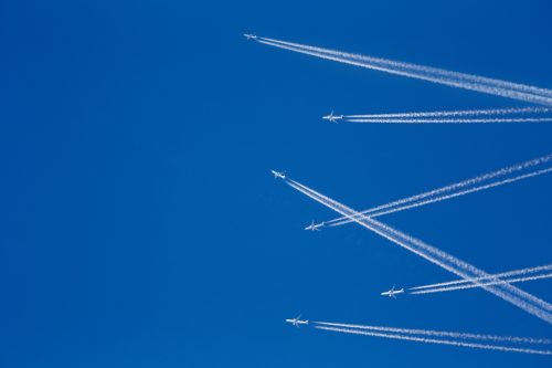 Multiple aircraft in the sky with chemtrails