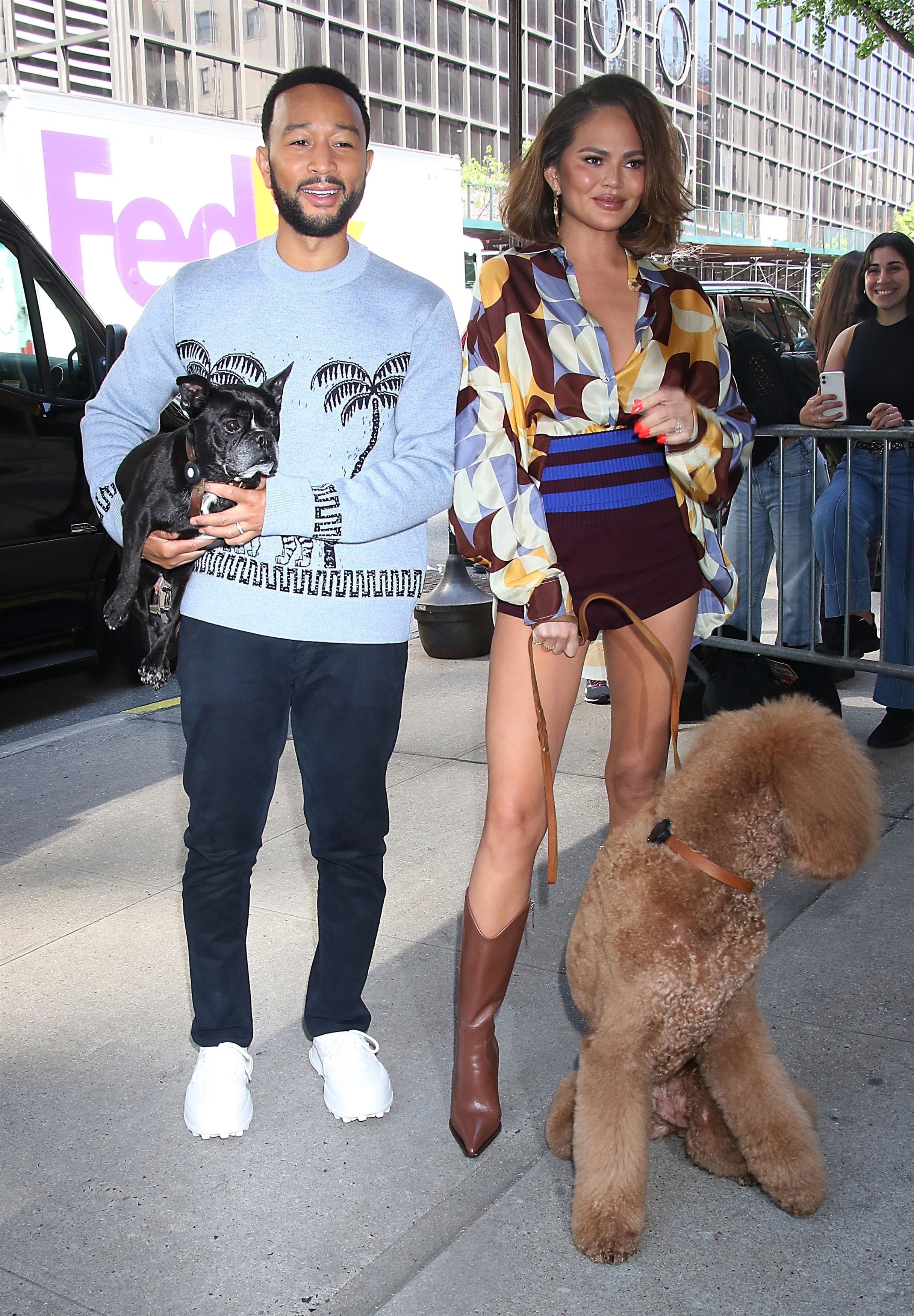 John Legend carried his furry companion as he walked with Chrissy