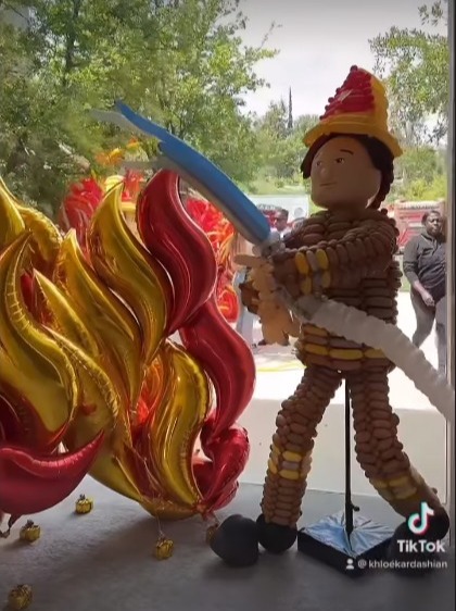 Outside, a balloon garland was created to look like a raging fire and a life-size balloon fireman was there to battle it