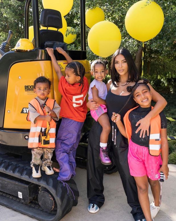 The mother-son duo posed in front of an orange bulldozer, while the following photo showed the reality TV star posing with all four of her children