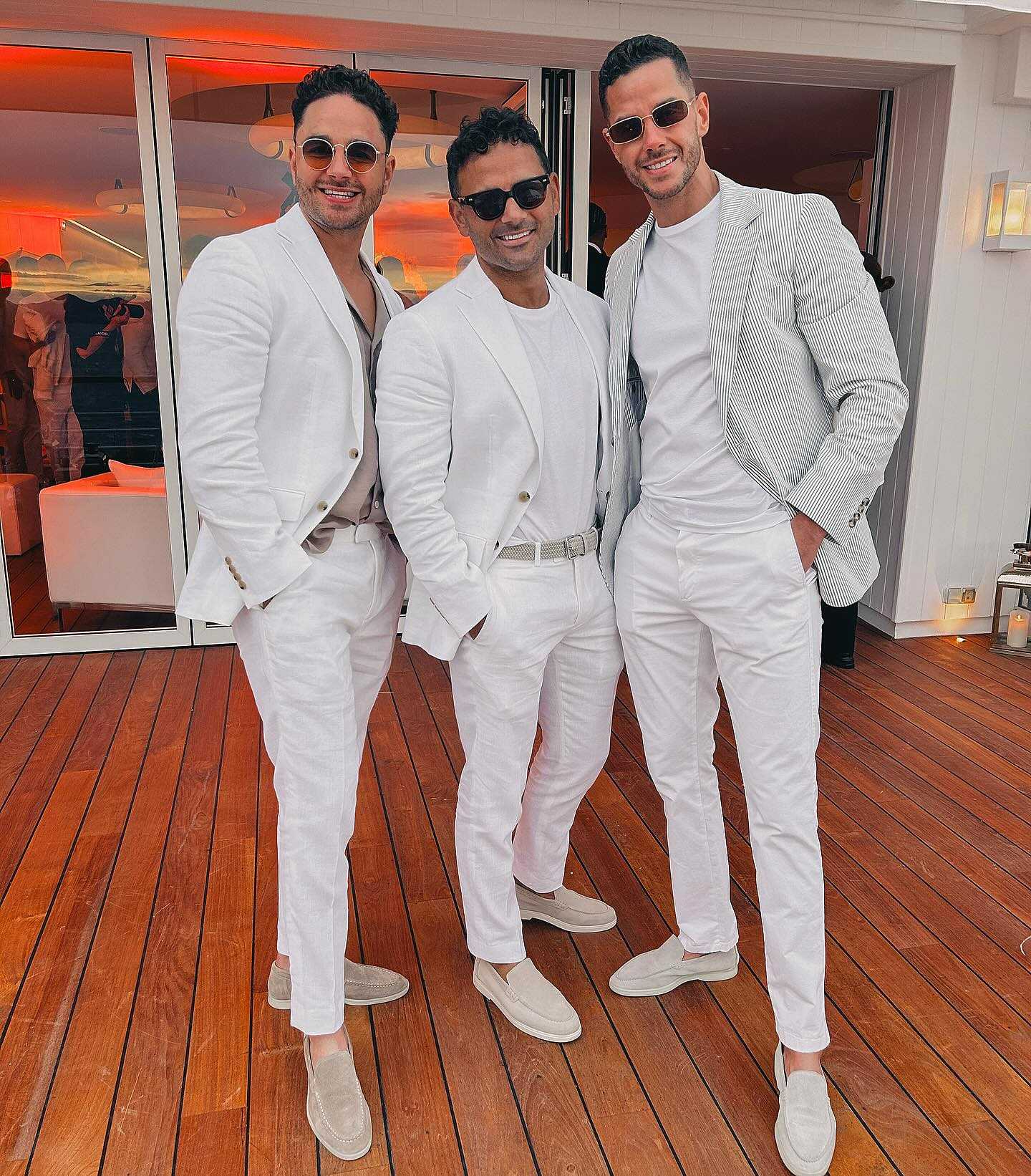 Ryan Thomas, who was the best man at the wedding, with Umar's brothers Alex and Scott