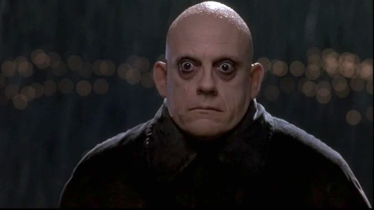 Bald pale Christopher Lloyd as Uncle Fester in The Addams Family
