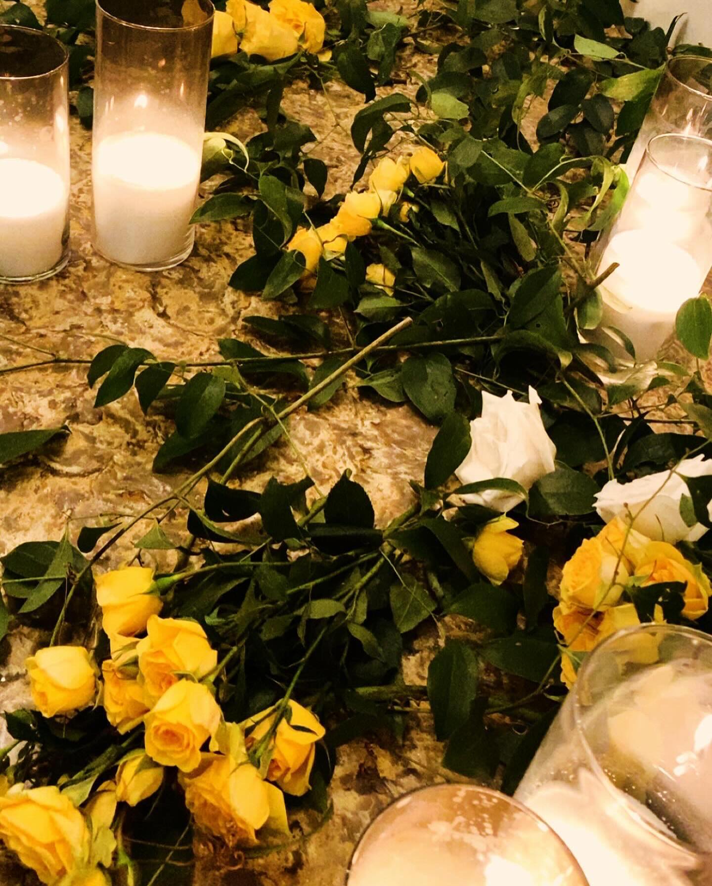 The decor was neutral, with white candles and yellow and white roses