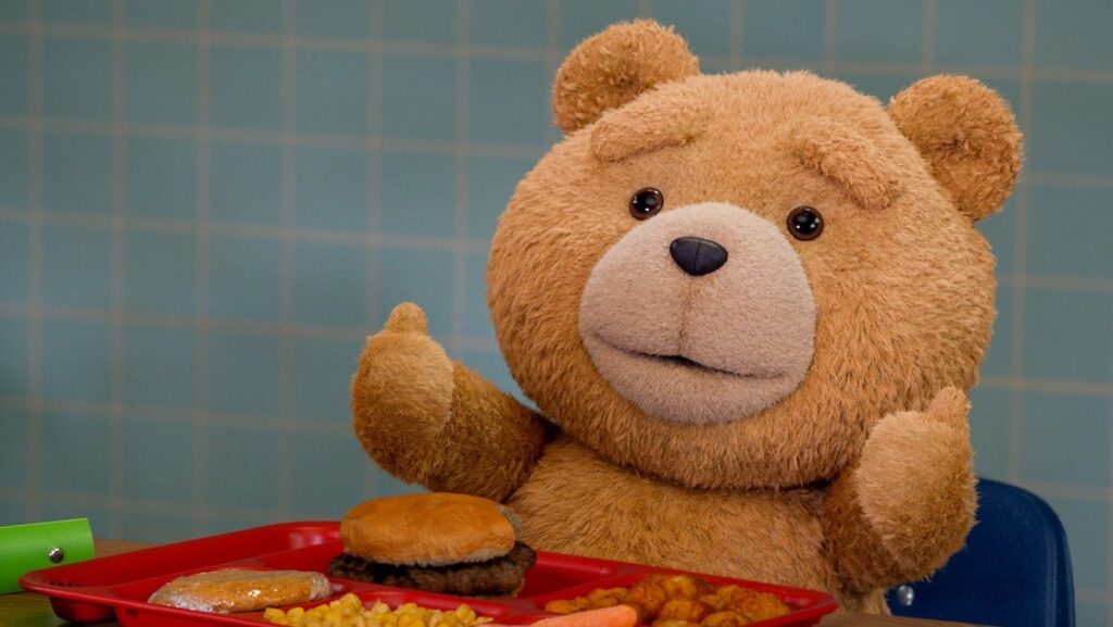 Ted giving thumbs up in front of a tray of food in a cafeteria