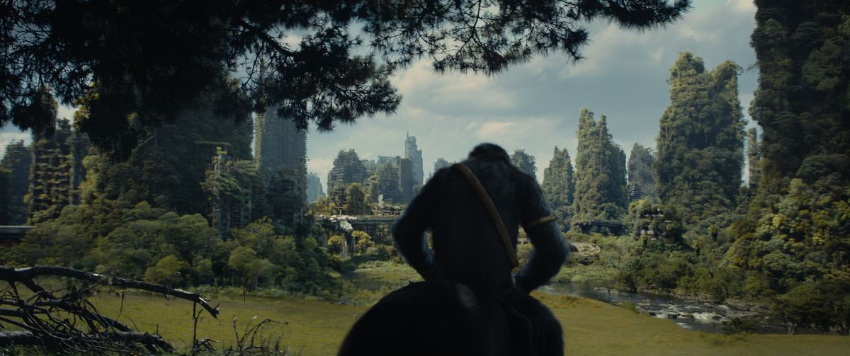 Noa rides a horse toward an overgrown human city in Kingdom of the Planet of the Apes