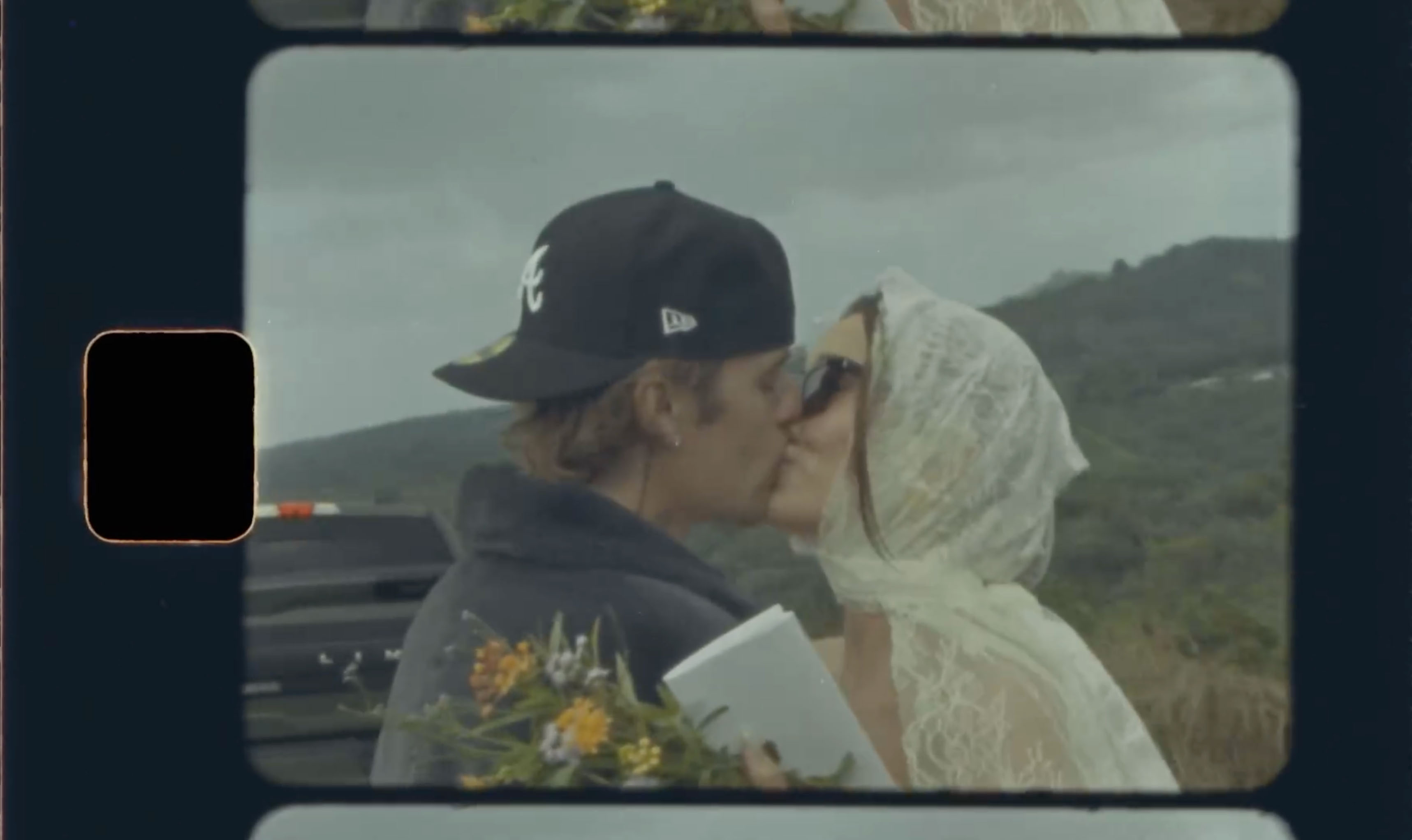 Justin sported a backward Atlanta Braves baseball cap as he was shown kissing his wife of five years