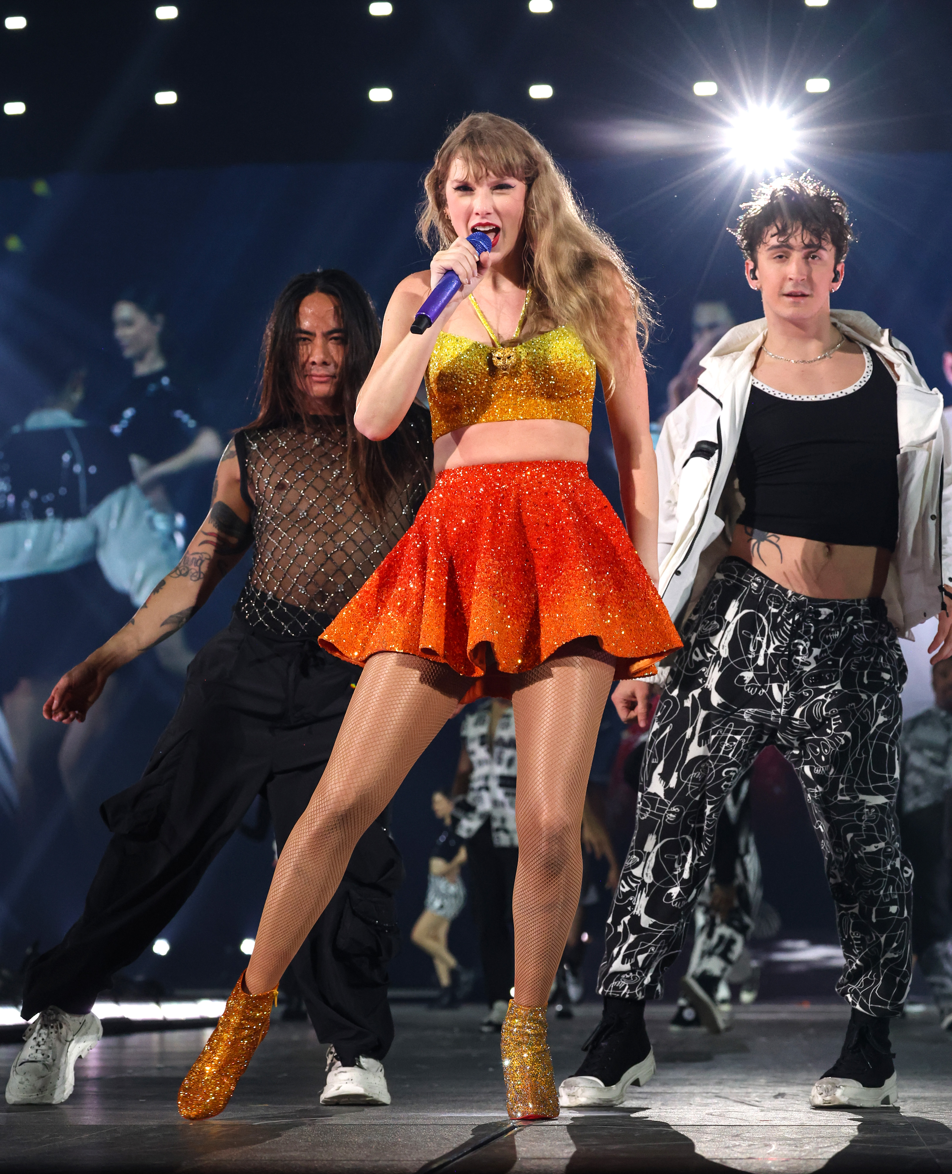 The pop star donned a glittery yellow crop top and a sparking red skirt as she rocked the stage