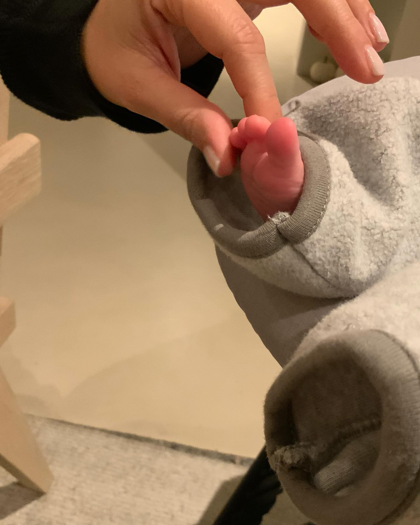 The 45-year-old squeezed Rocky's tiny toes in a cute close-up
