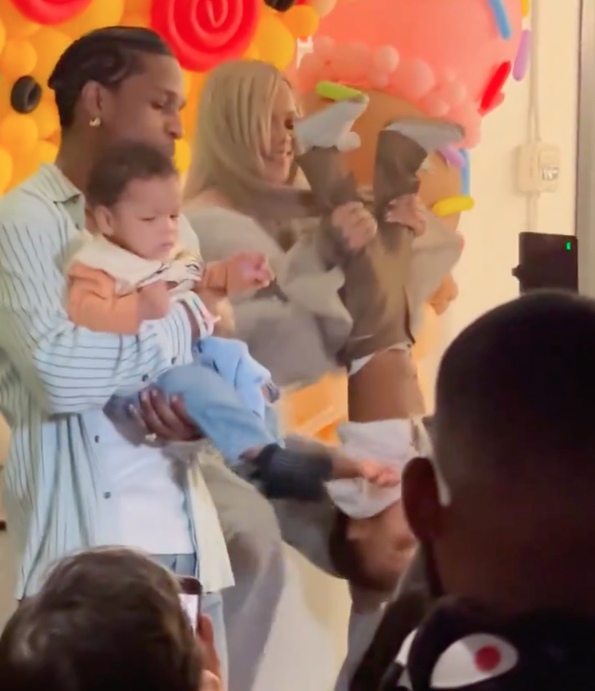 A video emerged of the singer holding the tiny tot upside down at his party