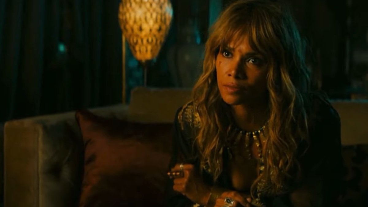 Halle Berry's Sofia sits on a couch in John Wick:: Chapter 3